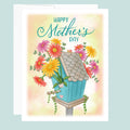 Mother's Day card with a blue birdhouse and flowers on a light blue background. 
