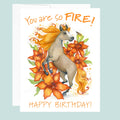 Birthday card with a horse and flowers on a light blue background.