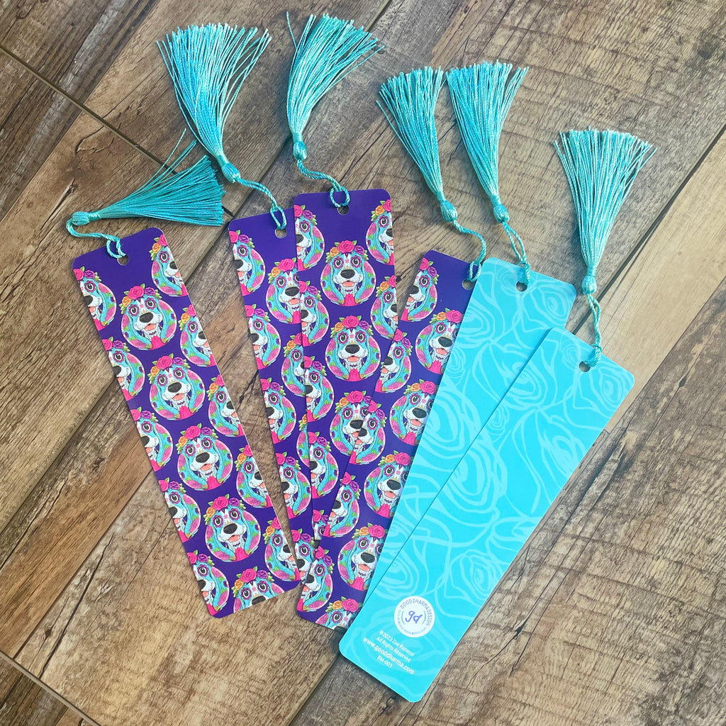 Colorful bookmarks with tassels on a wooden surface