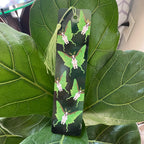 Bookmark with butterfly design on a green leaf background