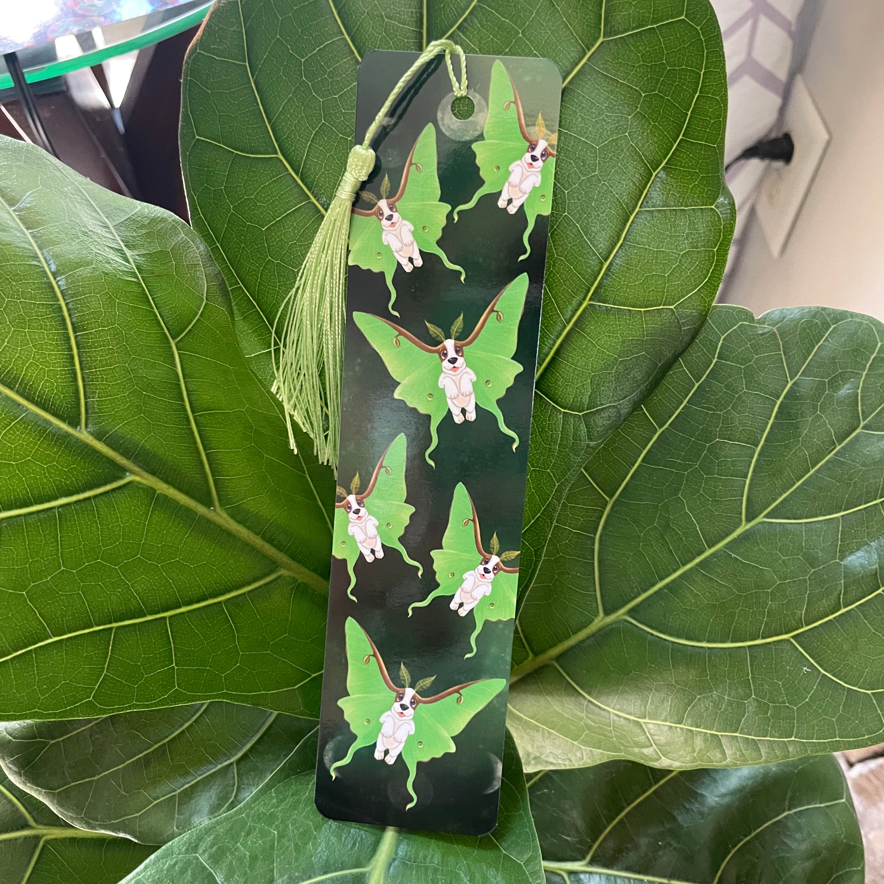 Bookmark with butterfly design on a green leaf background