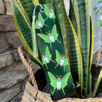 Green bookmark with butterfly design on a plant