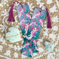 Two colorful bookmarks with axolotl designs on a textured surface with crystals.