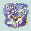 Arwork of a basset hound with crystals for ears and tail with words saying Shine On.