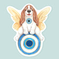 Artwork of an angelic basset hound with wings sitting on an evil eye symbol.