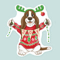 Artwork of a basset hound wearing antlers and ugly Christmas sweater holding banner saying JOY.
