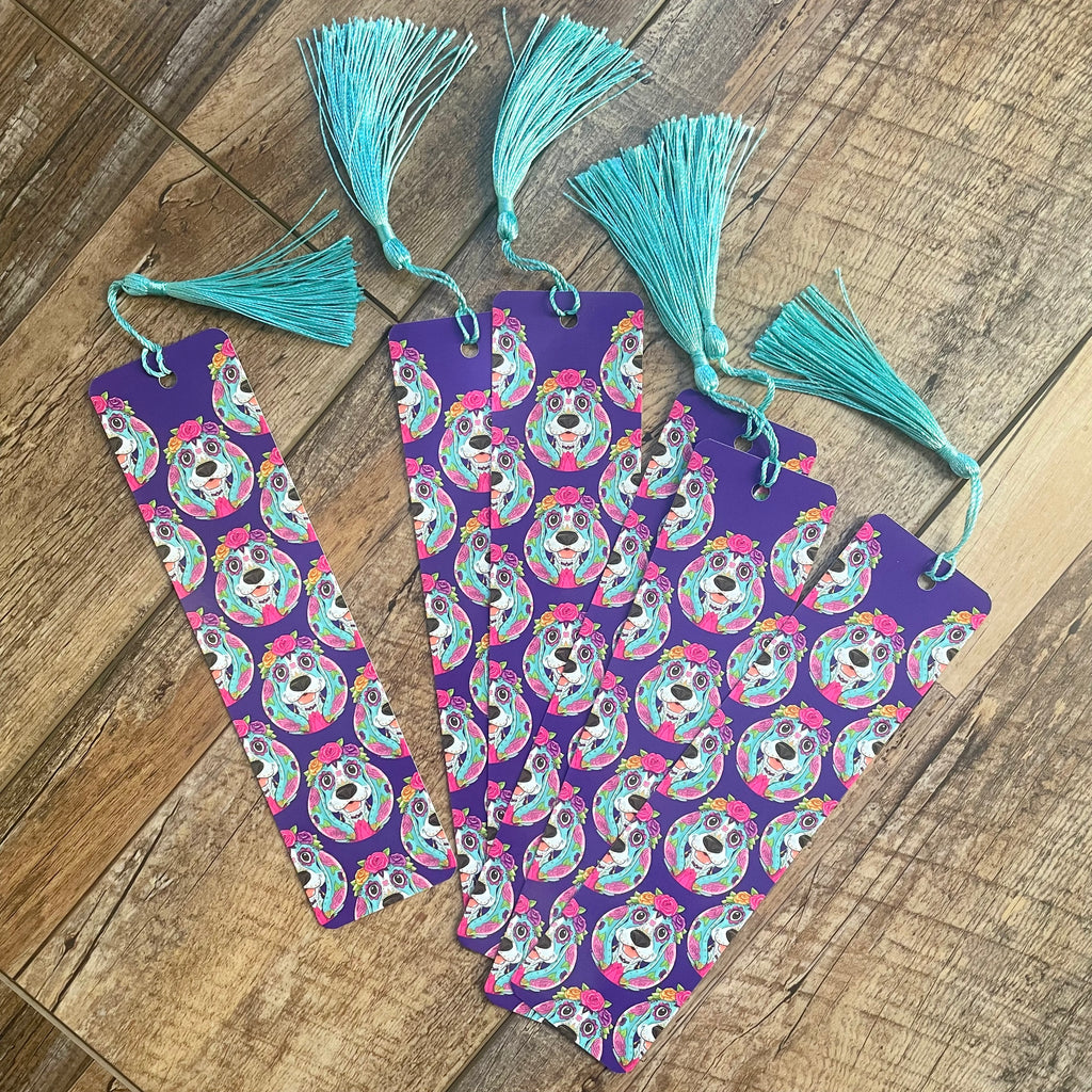 Set of colorful bookmarks with tassels on a wooden surface.