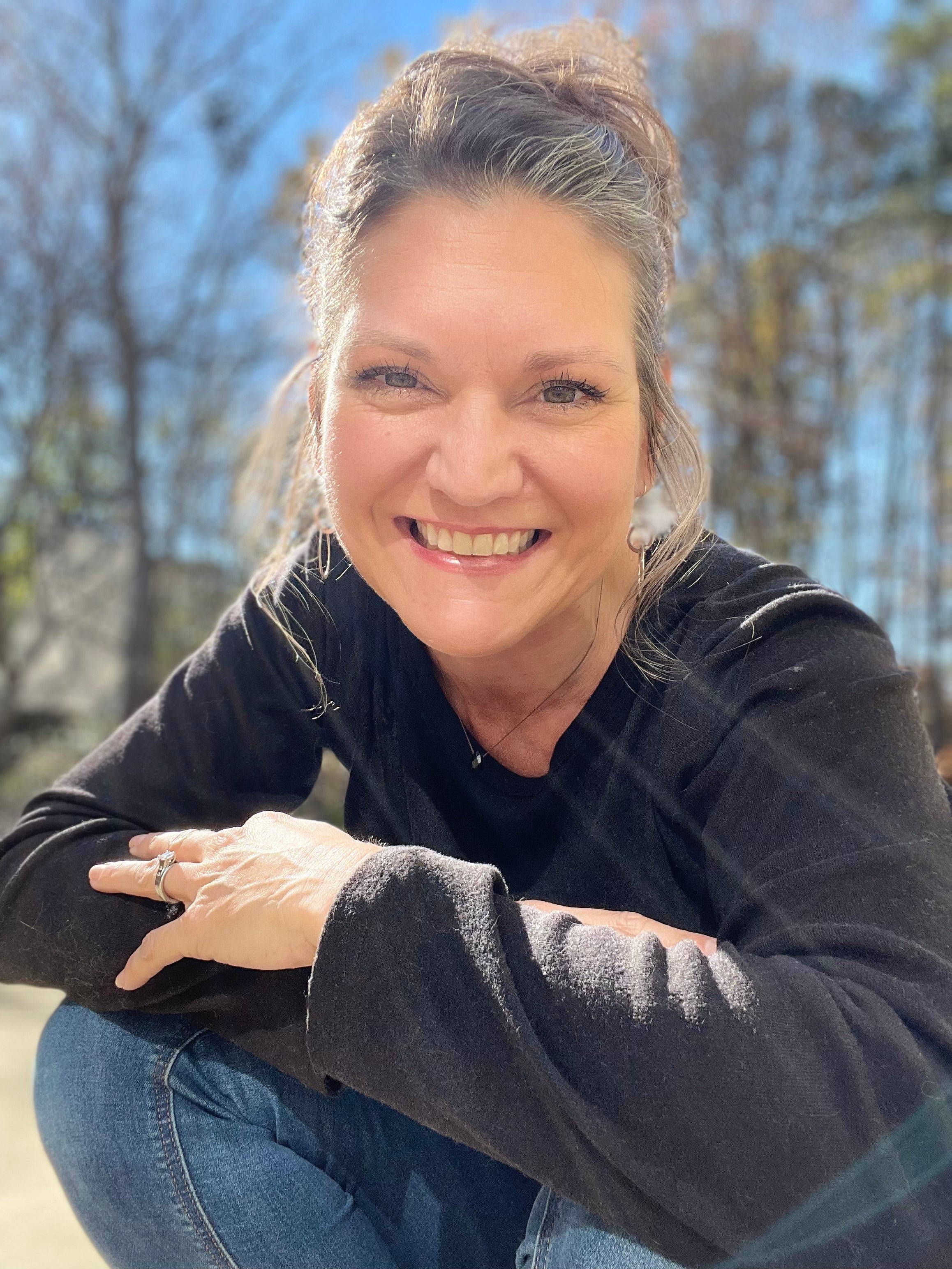 Zoe Ranucci sitting outdoors with trees in the background.