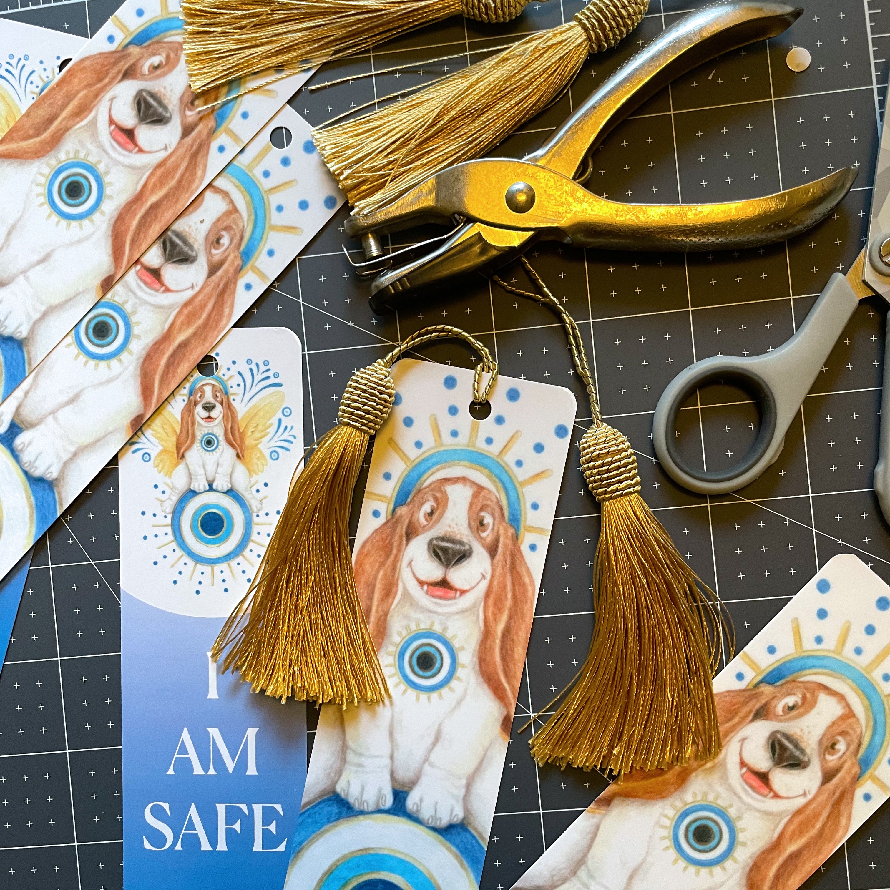 Dog-themed bookmarks with tassels and scissors on a cutting mat. ©Good Dharma Design by Zoe Ranucci